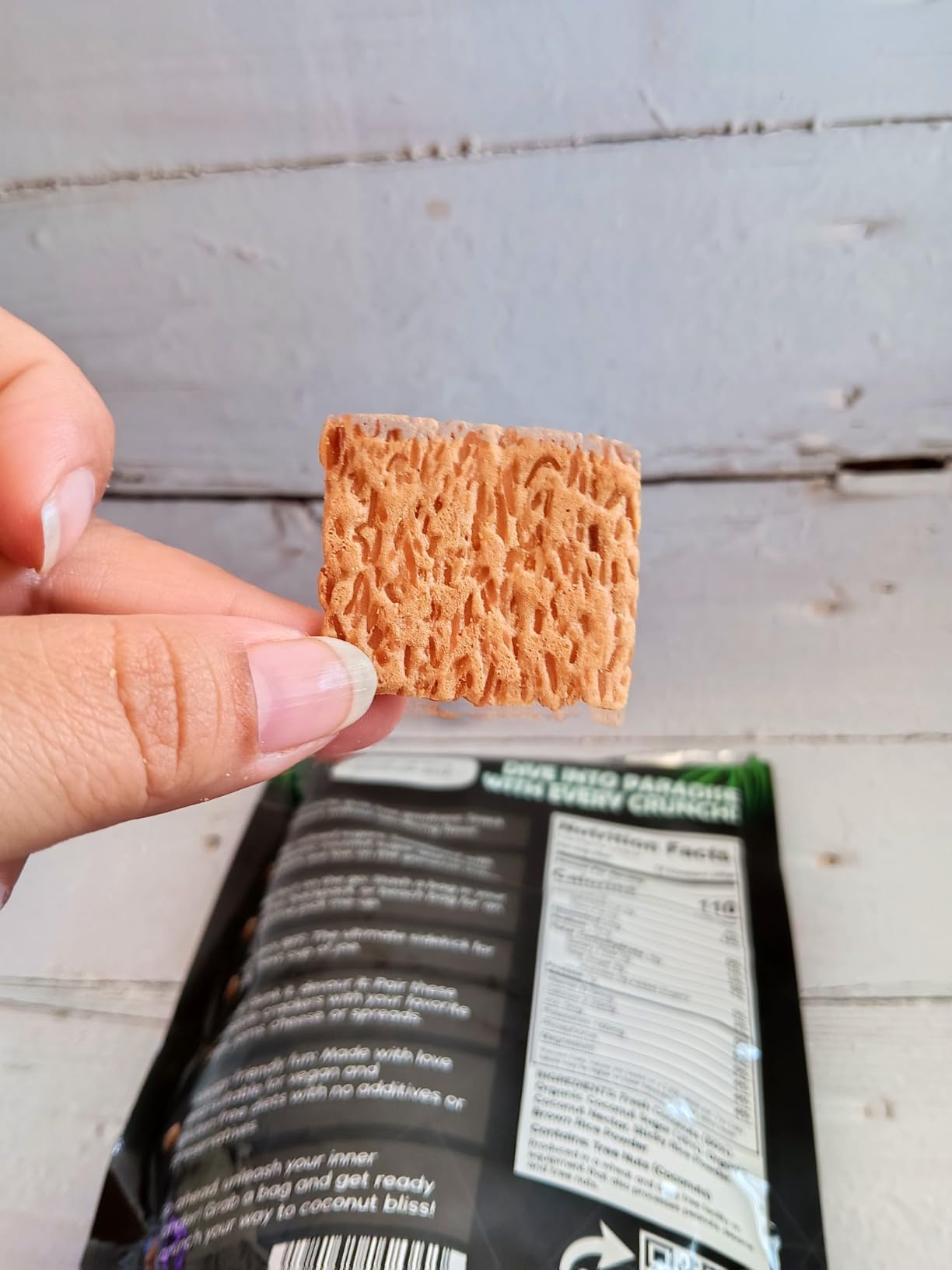person holding coconut cracker, gluten free snack